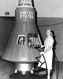 Jerrie Cobb poses next to a Mercury spacecraft (from Wikipedia)